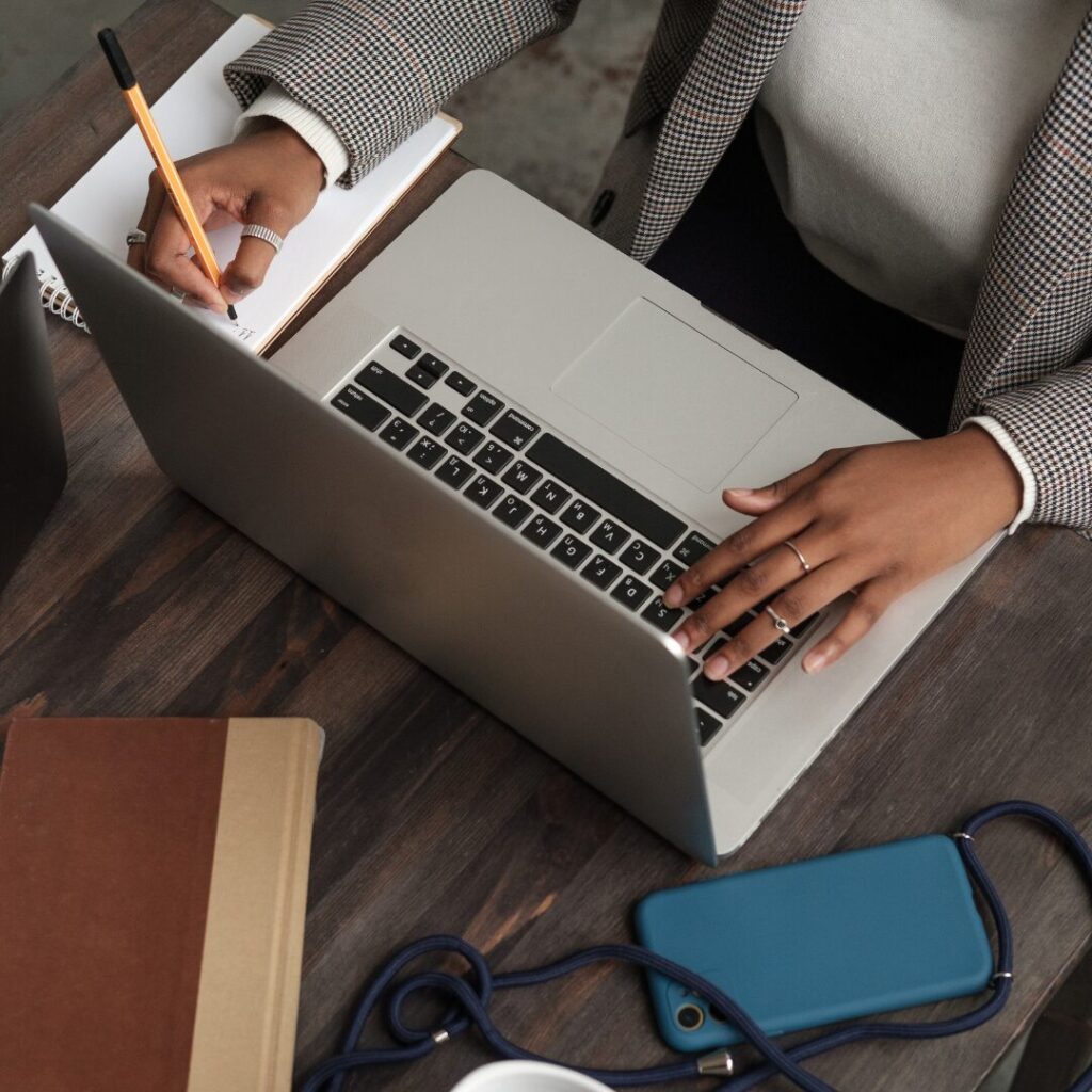 Woman calculating price differences between divorce lawyers on a laptop. 